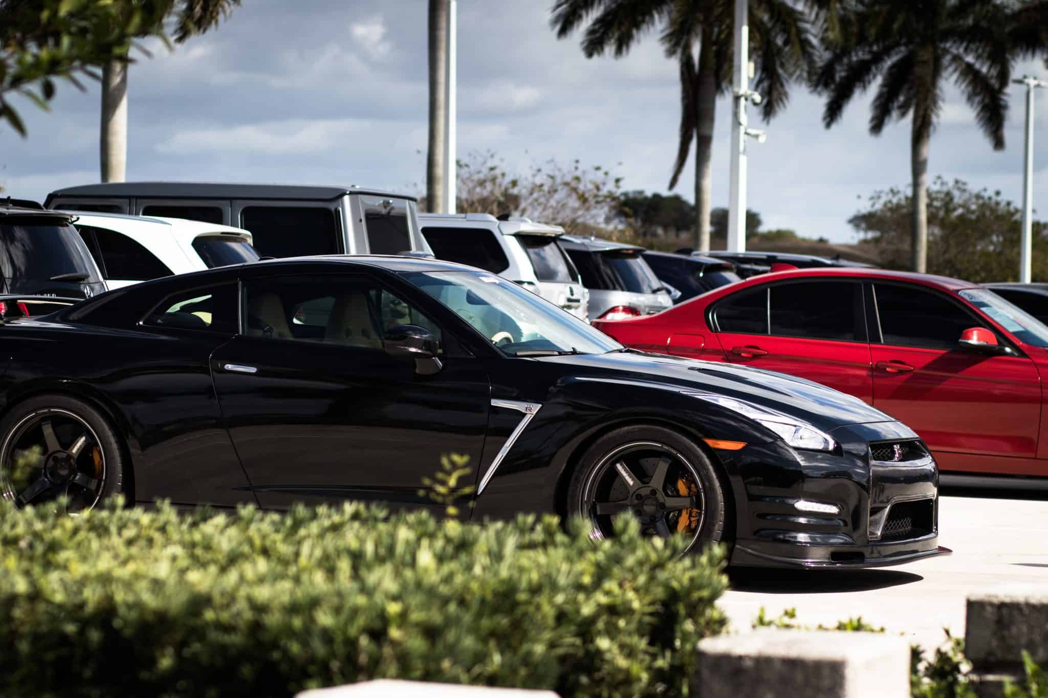 Black Nissan GT-R sports car parked in lot with other vehicles Cash for Cars Texas – Don't Trade It In